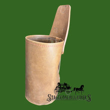 Load image into Gallery viewer, Beige leather Yeti Rambler holder with open top on a green background, featuring Stagecoach Leather logo.