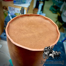 Load image into Gallery viewer, Brown Leater Yeti carrier bottom on a blurred background with manufacturer logo on bottom right hand